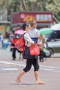 Chinese woman carry her child, Kunming, China