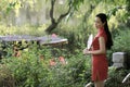 Chinese woman in cheongsam by a lake in Mudu ancient town