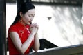 Chinese woman in cheongsam make a wish in Mudu ancient town