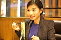 Chinese Woman eating noodles in restaurant Royalty Free Stock Photo