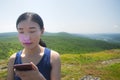 Chinese woman eyes shut alander mountain summit Royalty Free Stock Photo