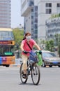 Chinese woman with mouth cap on a bicycle, Kunming, China