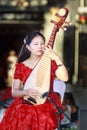 Chinese woman playing a pipa, a stringed instrument Royalty Free Stock Photo