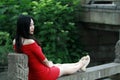 A Chinese woman in red dress in Feng Jing ancient town Royalty Free Stock Photo