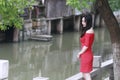 A Chinese woman in red dress in Feng Jing ancient town Royalty Free Stock Photo