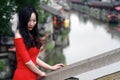 A Chinese woman in red dress in Feng Jing ancient town Royalty Free Stock Photo