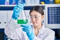 Chinese woman scientist measuring liquid working at laboratory Royalty Free Stock Photo