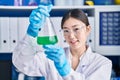 Chinese woman scientist measuring liquid working at laboratory Royalty Free Stock Photo