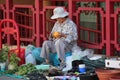 Chinatown Woman Vendor Displaying a colorful red Array