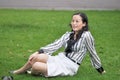 A Chinese Woman Sit On The Grass