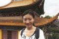 Chinese woman standing before buddhist hall