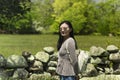 Chinese woman standing near rock wall new england Royalty Free Stock Photo