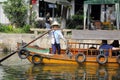 Chinese woman standing and rowing boat Royalty Free Stock Photo