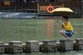 Chinese woman taking selfie on stepping stones in Fenghuang