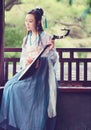 Chinese woman in traditional Hanfu dress,play traditional instrument of pipa Royalty Free Stock Photo