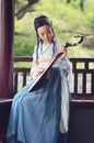 Chinese woman in traditional Hanfu dress,play traditional instrument of pipa Royalty Free Stock Photo