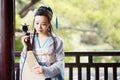 Chinese woman in traditional Hanfu dress,play traditional instrument of pipa Royalty Free Stock Photo