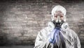 Chinese Woman Wearing Hazmat Suit, Protective Gas Mask and Goggles Against Brick Wall Royalty Free Stock Photo