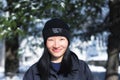 A chinese woman wearing a mountain hardwear winter hat