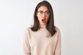 Chinese woman wearing turtleneck sweater and glasses over isolated white background scared in shock with a surprise face, afraid Royalty Free Stock Photo