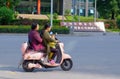 Chinese women and child riding scooter in China