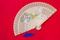 Chinese wooden foldable fan on red background Asian style hand fan Royalty Free Stock Photo