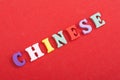 CHINESE word on red background composed from colorful abc alphabet block wooden letters, copy space for ad text. Learning english Royalty Free Stock Photo