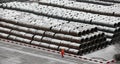 A Chinese worker walked piled rod freight yard