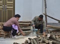Chinese workers cutting tree wood