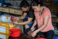 Chinese workers peeling skin off small fish