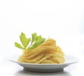 Chinese yellow eggs noodle on white disk with green leaves of ce Royalty Free Stock Photo