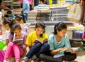 Chinese young school girls sitting on the floor and reading books at the Shenzhen Central Bookstore in Futian district, Shenzhen,