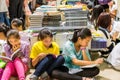 Chinese young school girls sitting on the floor and reading books at the Shenzhen Central Bookstore in Futian district, Shenzhen,