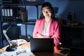 Chinese young woman working at the office at night happy face smiling with crossed arms looking at the camera Royalty Free Stock Photo
