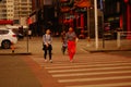 Chinese young women crossing the road