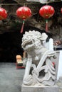 Chineselion statue stand in front of cave