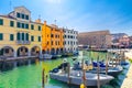 Chioggia cityscape with narrow water canal Vena with moored multicolored boats