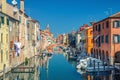Chioggia cityscape with narrow water canal Vena with moored multicolored boats