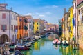 Chioggia cityscape with narrow water canal Vena with moored multicolored boats