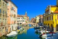 Chioggia cityscape with narrow water canal Vena with moored multicolored boats