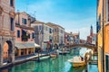 Chioggia cityscape with narrow water canal Vena with moored multicolored boats