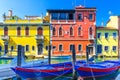 Chioggia cityscape with narrow water canal Vena with moored multicolored boats