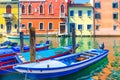 Chioggia cityscape with narrow water canal Vena with moored multicolored boats Royalty Free Stock Photo
