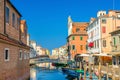 Chioggia cityscape with narrow water canal Vena with moored multicolored boats