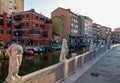 Chioggia - Collection of ancient statues graces peaceful water canal in the charming town of Chioggia