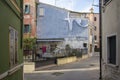 Chioggia, ITALY - June 4, 2022: Pictoresque streets of old town Sottomarina, colorful buldings in sunlight, blue sky