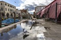 Chioggia, Venice, Italy: landscape of the old town and the canal with fishing boats and ancient buildings. Street Reflex