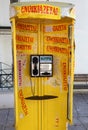 Yellow Phone Booth with Stickers, Notes and Numbers in Chios, Greece