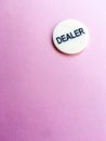 Chip dealer lies on a pink background. The game of poker. Place for text. Gambling. Royalty Free Stock Photo