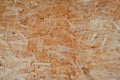 Chipboard building material. OSB wooden panel made of pressed sandy brown wood shavings as background closeup Royalty Free Stock Photo